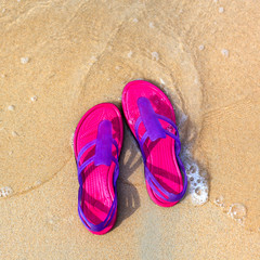 Fototapeta na wymiar Sandals on the beach - concept image