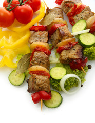 tasty grilled meat and vegetables on skewers, isolated on white