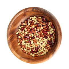 Beans in wooden bowl isolated on white