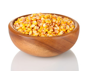Corn in wooden bowl isolated on white