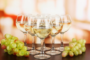 White wine in glass on room background