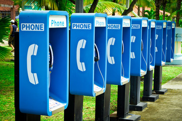 Blue public phone in a row