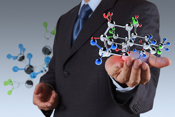 businessman holding a molecule