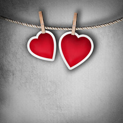 Valentine background: two hearts hanging on clothespin. Couple c