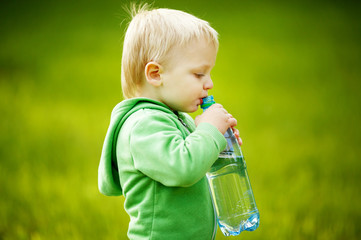 little boy drinks mineral water