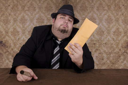 Gangster holding brown envelope