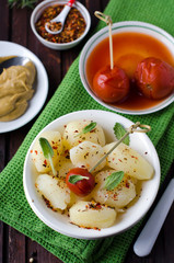 Boiled potatoes with herbs and pickled tomatoes