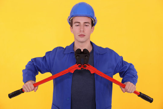 Builder using bolt cutters