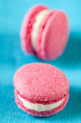 Vanilla flavoured macaroons on a turquoise serviette