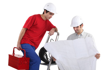 craftsmen looking at a blueprint