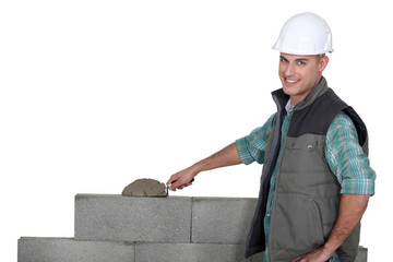 Bricklayer building a block wall