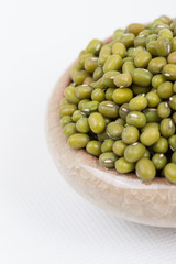 Green mung beans in bowl on white background