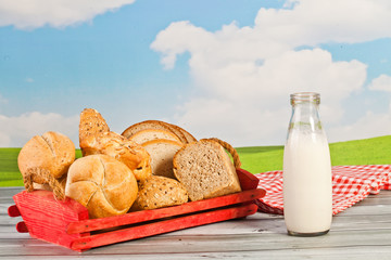 bread, milk, butter on a background of the sky - a picnic