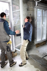 Two men fitting new window