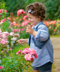 Baby girl in rose garden