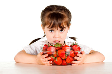 A child with a bowl fresh strawberries