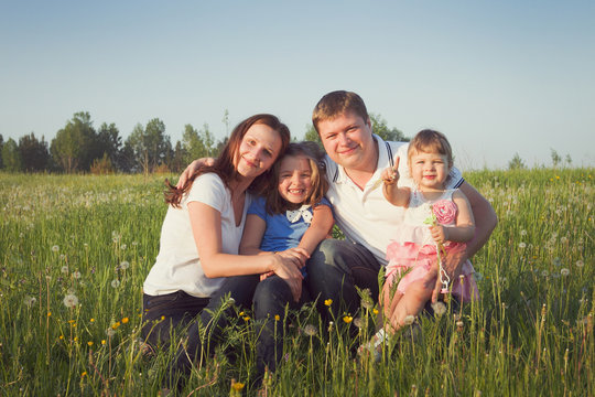 parents and two daughters outdoors portrait