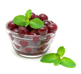 frozen cherries and mint sprigs on a white background