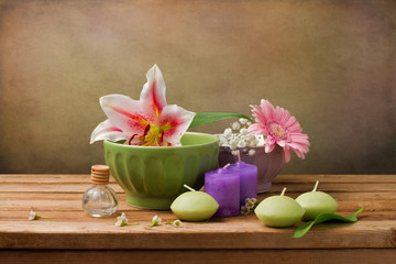 Still life with flowers and candles on wooden table