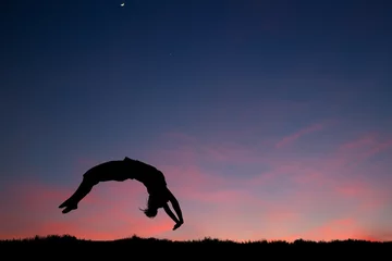 Foto op Plexiglas gymnast in sunset doing a back handspring © Alex Koch