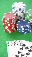 Cards and chips for poker on green table