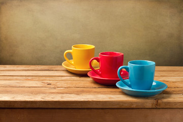 Colorful empty coffee cups on wooden table