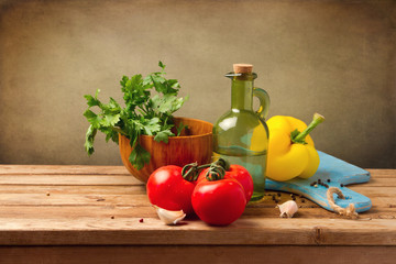 Fresh healthy vegetables on wooden table over grunge background