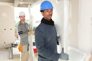 Workers carrying glass