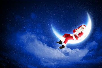 photo of santa claus sitting on the moon