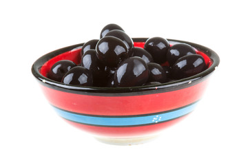 Olives black watered with olive oil in a bowl isolated on a whit