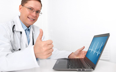 Fototapeta na wymiar Doctor with laptop sitting in doctor's office