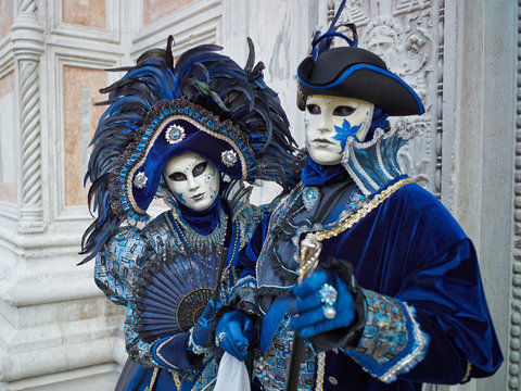 Fototapeta Person in Venetian costume attends Carnival of Venice.