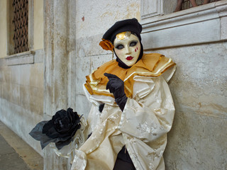 Person in Venetian costume attends Carnival of Venice.