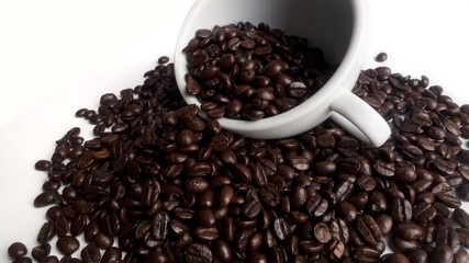 A white cup with beans coffee