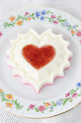 two-layer  of cream dessert with jam on a plate