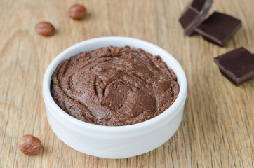 walnut-chocolate paste in a white bowl, closeup