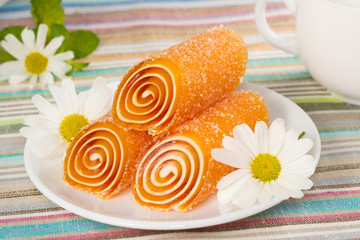 orange colorful candies jelly with flower, background