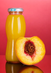 Delicious peach juice in bottle and peach next to it