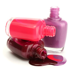 open bottles with bright nail polish isolated on white