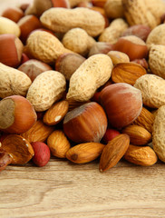 assortment of tasty nuts on wooden background