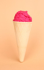 Scoop of the strawberry ice cream in the waffle cone