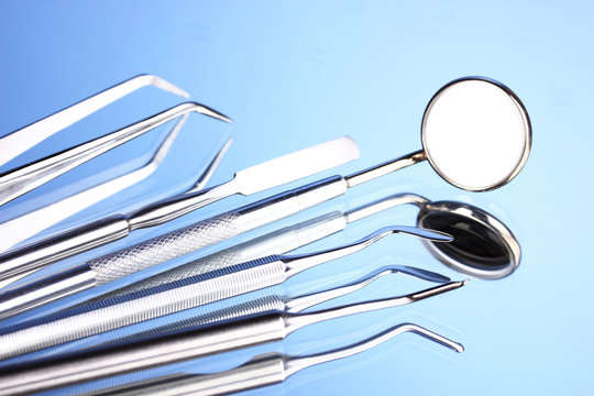 Set of dental tools for teeth care isolated on blue background
