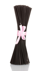 Black spaghetti with ribbon isolated on white