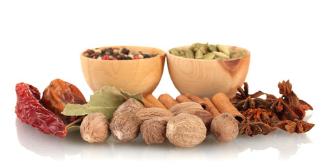 Nutmeg and other spices isolated on white