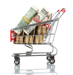 shopping trolley with dollars and Ukrainian coins, isolated