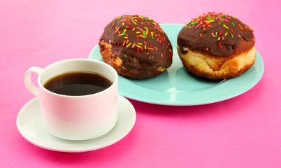 Tasty donuts on color plate on color background