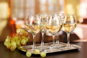 White wine in glass on room background