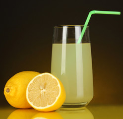 Delicious lemon juice in glass and lemons next to it