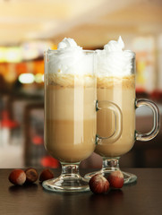 Fragrant coffee latte in glasses cups with nuts,
