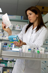 Beautiful woman pharmacist searching medicine with prescription